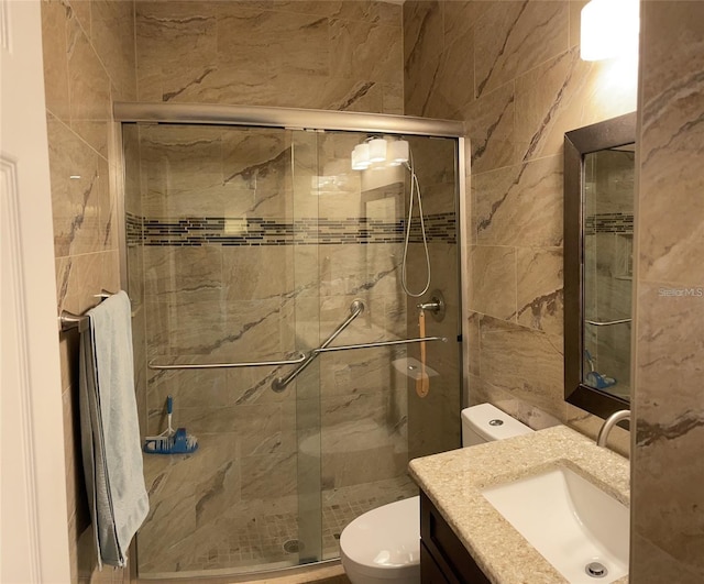 bathroom with toilet, tile walls, walk in shower, and vanity