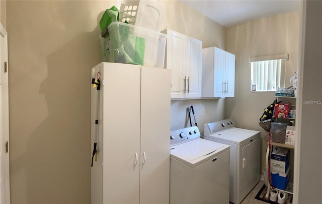 washroom with cabinets and independent washer and dryer