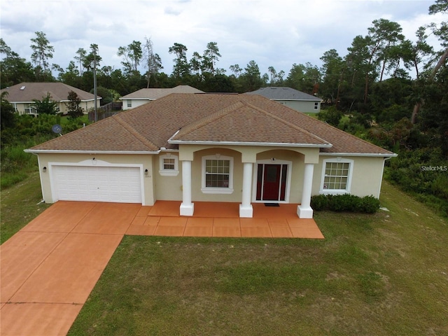 view of front of property with an attached garage, a front lawn, concrete driveway, stucco siding, and a shingled roof