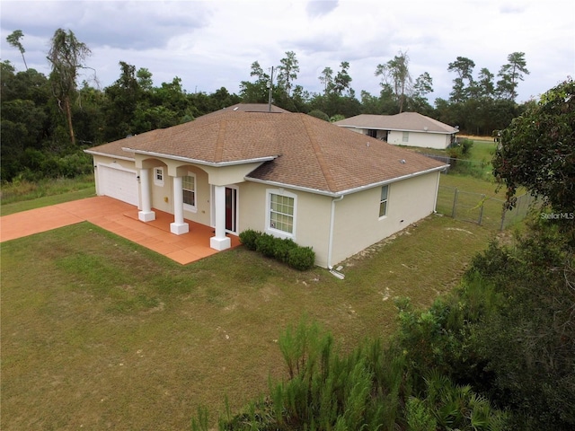 view of front of home with driveway, a garage, stucco siding, and a shingled roof