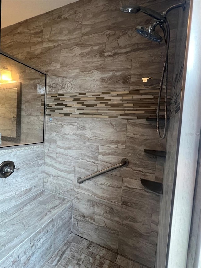 bathroom with tiled shower