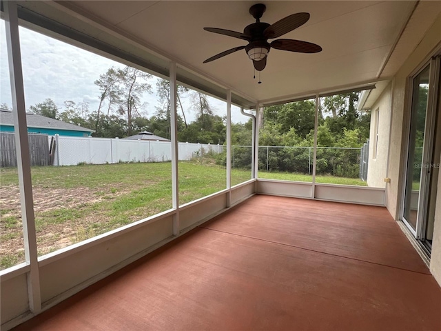 unfurnished sunroom with ceiling fan
