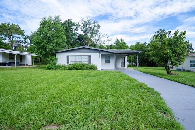 single story home with a front lawn and a carport