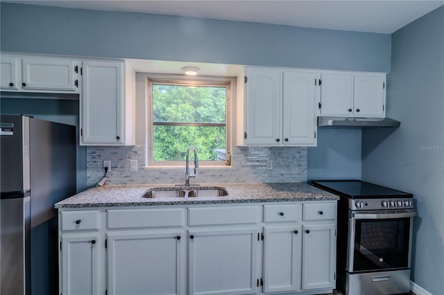 kitchen featuring stainless steel appliances, white cabinets, tasteful backsplash, and sink