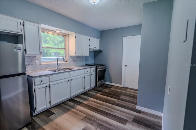 kitchen with backsplash, sink, stainless steel appliances, white cabinets, and dark hardwood / wood-style flooring