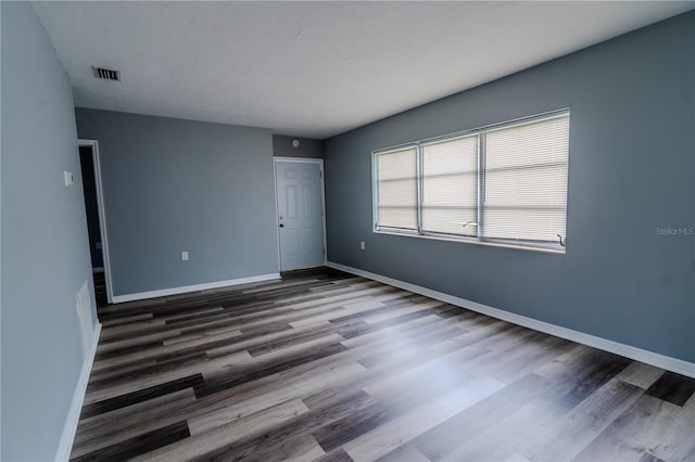 spare room featuring dark wood-type flooring