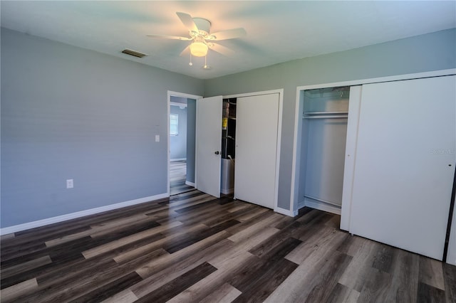 unfurnished bedroom with dark wood-type flooring and ceiling fan