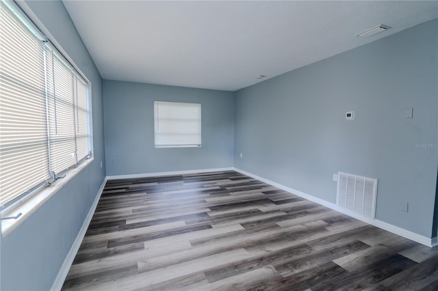 unfurnished room with dark hardwood / wood-style floors