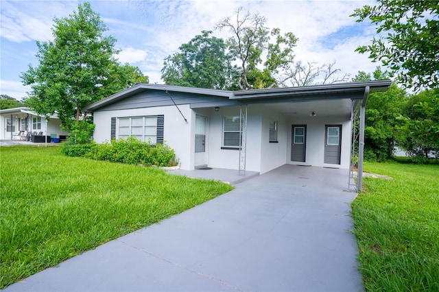 ranch-style house with a carport and a front yard