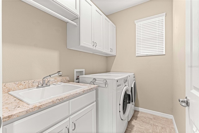 laundry room featuring cabinets, sink, and washing machine and dryer