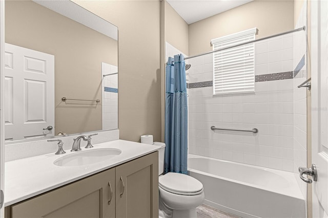 full bathroom with vanity, shower / bath combo, and toilet