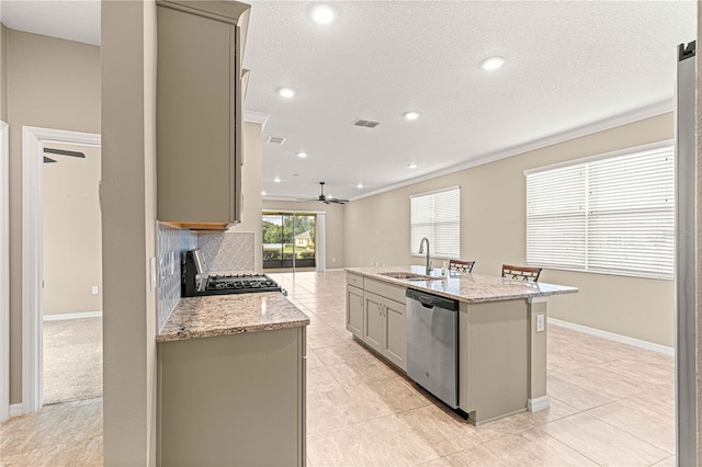 kitchen with sink, gray cabinets, dishwasher, a kitchen island with sink, and stove