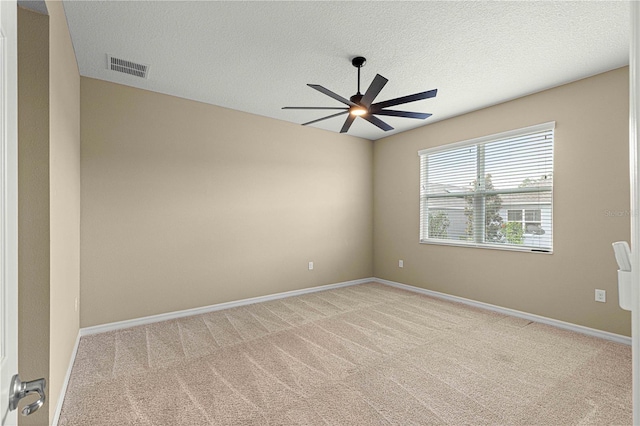 unfurnished room with light carpet, a textured ceiling, and ceiling fan