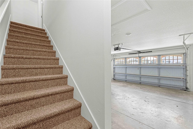 staircase with concrete flooring and a textured ceiling