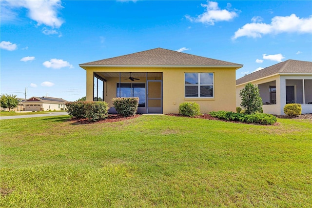 view of front of property with a front yard and ceiling fan