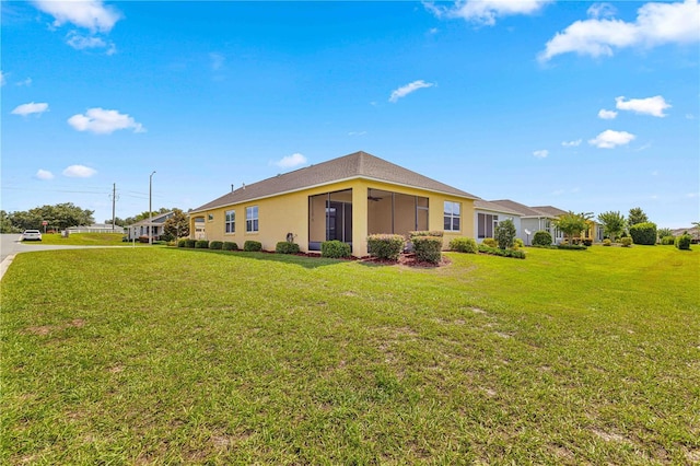 back of property featuring a yard