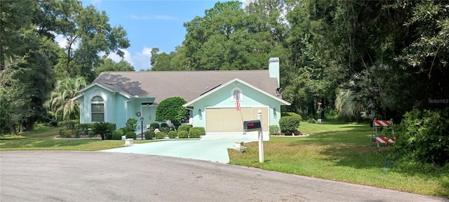 view of front of house featuring a front yard and a garage