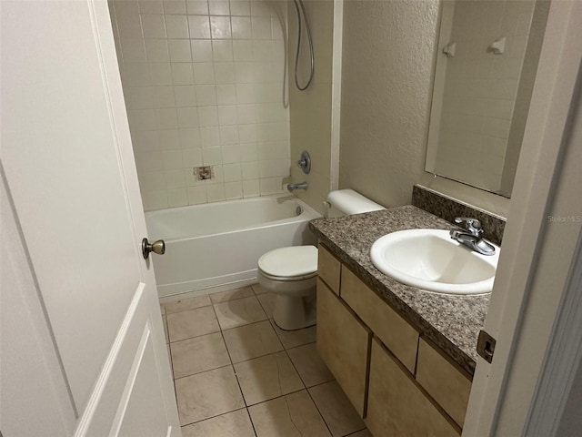 full bathroom featuring tile patterned flooring, toilet, vanity, and tiled shower / bath