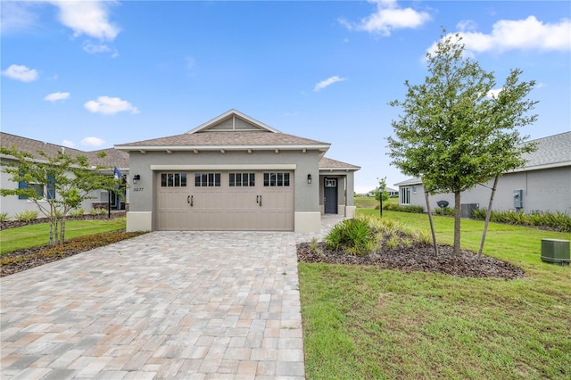 view of front of property with a garage and a front lawn