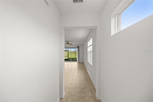 corridor with light tile patterned floors