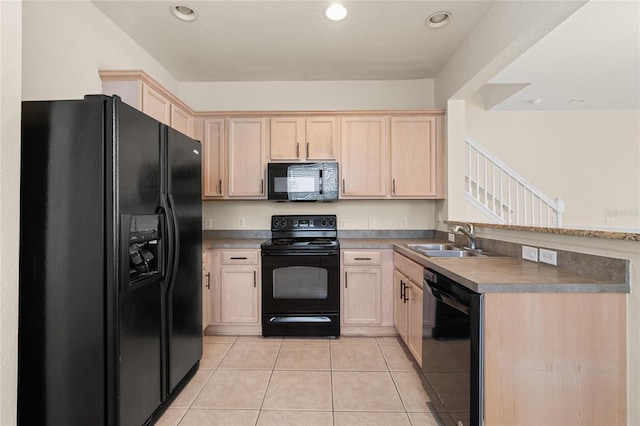 kitchen with black appliances, light tile patterned flooring, light brown cabinetry, and sink