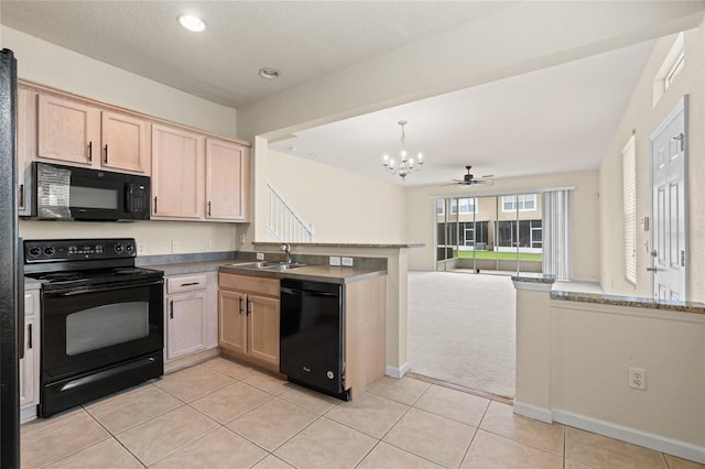 kitchen featuring black appliances, kitchen peninsula, light carpet, and sink