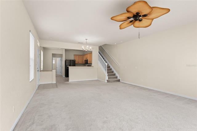 unfurnished living room with light carpet and a chandelier