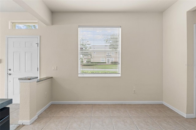 tiled spare room with plenty of natural light