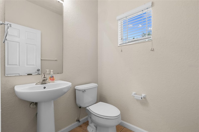 bathroom with sink, tile patterned floors, and toilet