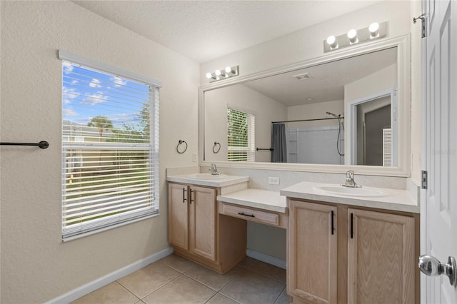 bathroom featuring a textured ceiling, tile patterned floors, vanity, and a shower with curtain