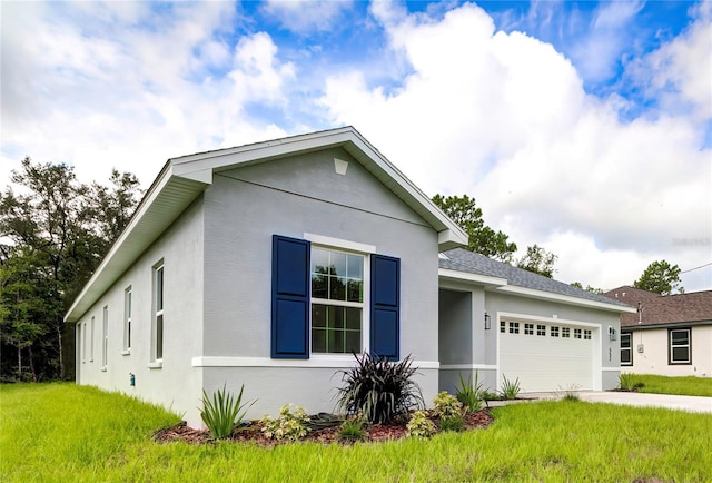 ranch-style home featuring an attached garage, a shingled roof, concrete driveway, and stucco siding