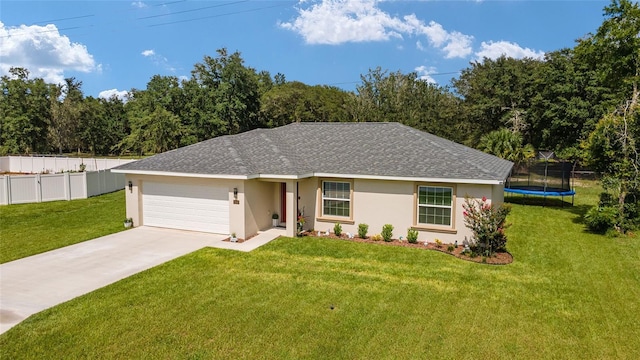 single story home with a garage, a front yard, and a trampoline