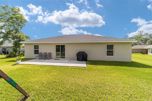 back of property featuring a patio and a lawn