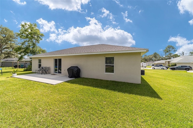 rear view of property with a patio and a yard