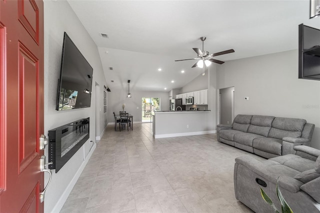 living room featuring ceiling fan and vaulted ceiling