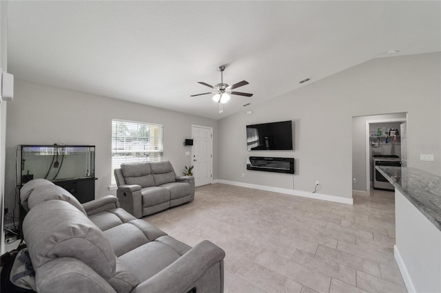 living room with ceiling fan and lofted ceiling