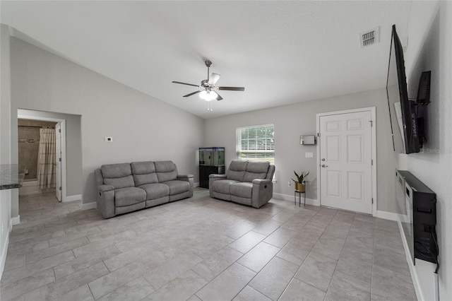 tiled living room with ceiling fan and lofted ceiling