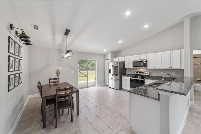 kitchen featuring white cabinets, appliances with stainless steel finishes, sink, hanging light fixtures, and kitchen peninsula