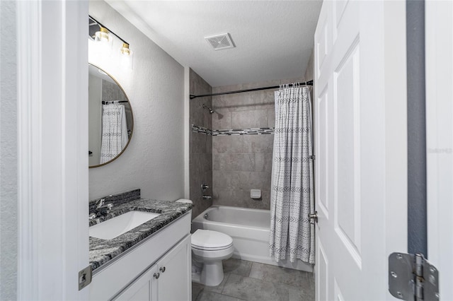 full bathroom featuring toilet, a textured ceiling, shower / tub combo, and vanity