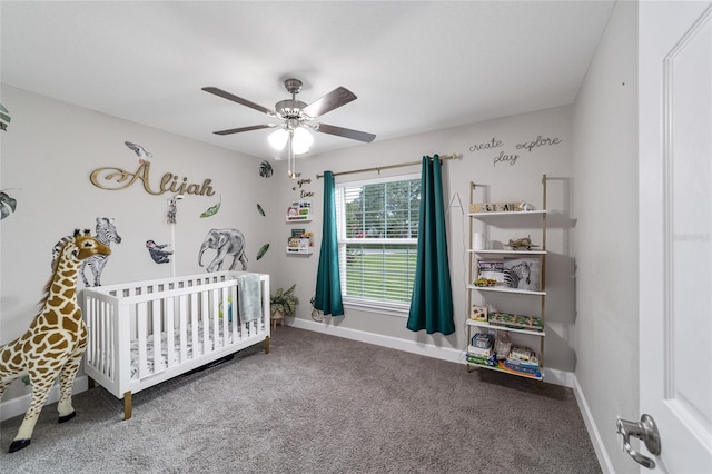 carpeted bedroom with ceiling fan and a nursery area