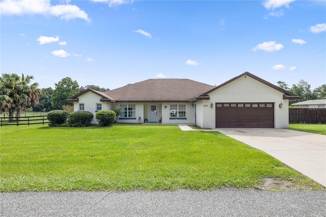 ranch-style house featuring a garage and a front yard