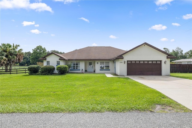 ranch-style home featuring a garage and a front yard