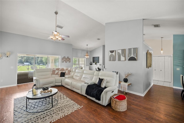 living room with dark wood-type flooring, ceiling fan, and high vaulted ceiling