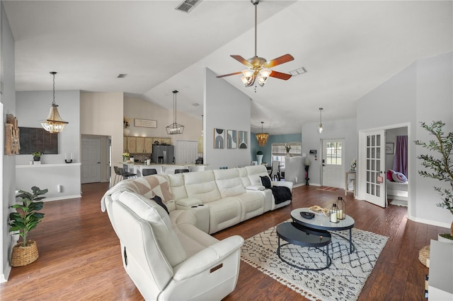 living room featuring hardwood / wood-style floors, ceiling fan with notable chandelier, high vaulted ceiling, and french doors