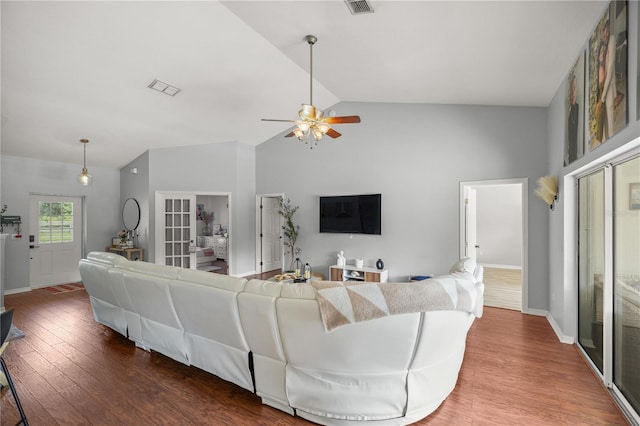 living room featuring ceiling fan, vaulted ceiling, and hardwood / wood-style floors