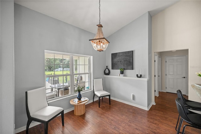 living area featuring lofted ceiling, a notable chandelier, and dark hardwood / wood-style flooring