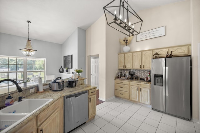 kitchen with pendant lighting, sink, stainless steel appliances, and light brown cabinets