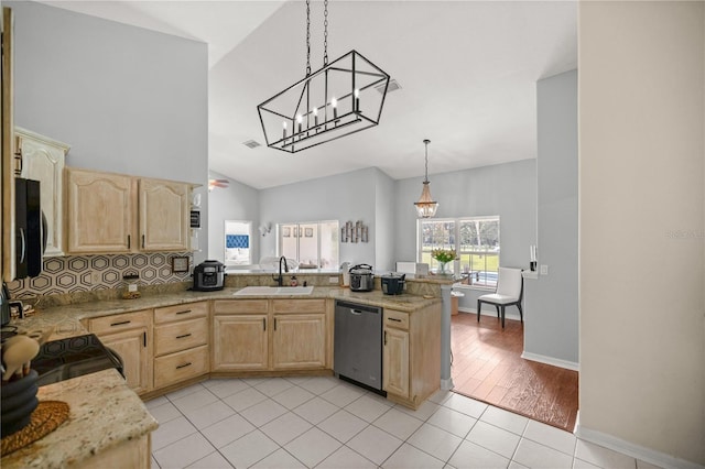 kitchen featuring sink, decorative light fixtures, light brown cabinets, light tile patterned floors, and stainless steel dishwasher