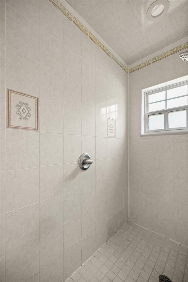 bathroom with a tile shower