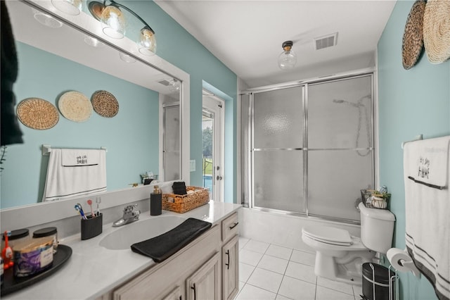 full bathroom with toilet, tile patterned floors, bath / shower combo with glass door, and vanity